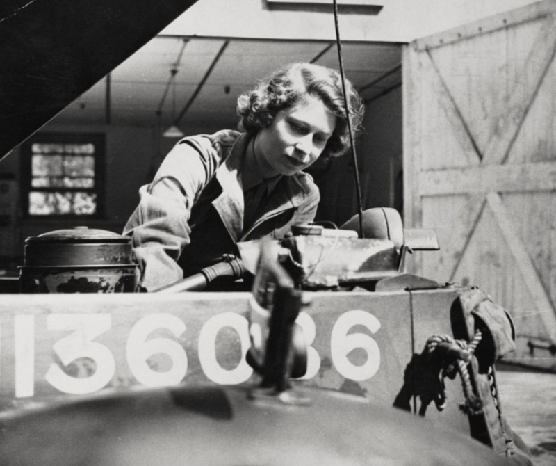 6. Female British military mechanic fixes a jeep motor, 1945