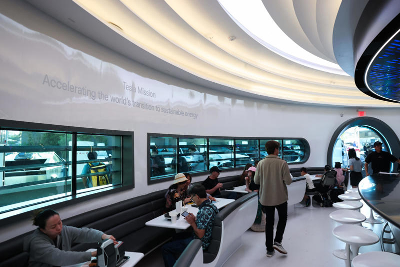 Wallpaper inside the restaurant broadcasts Tesla's mission to diners.